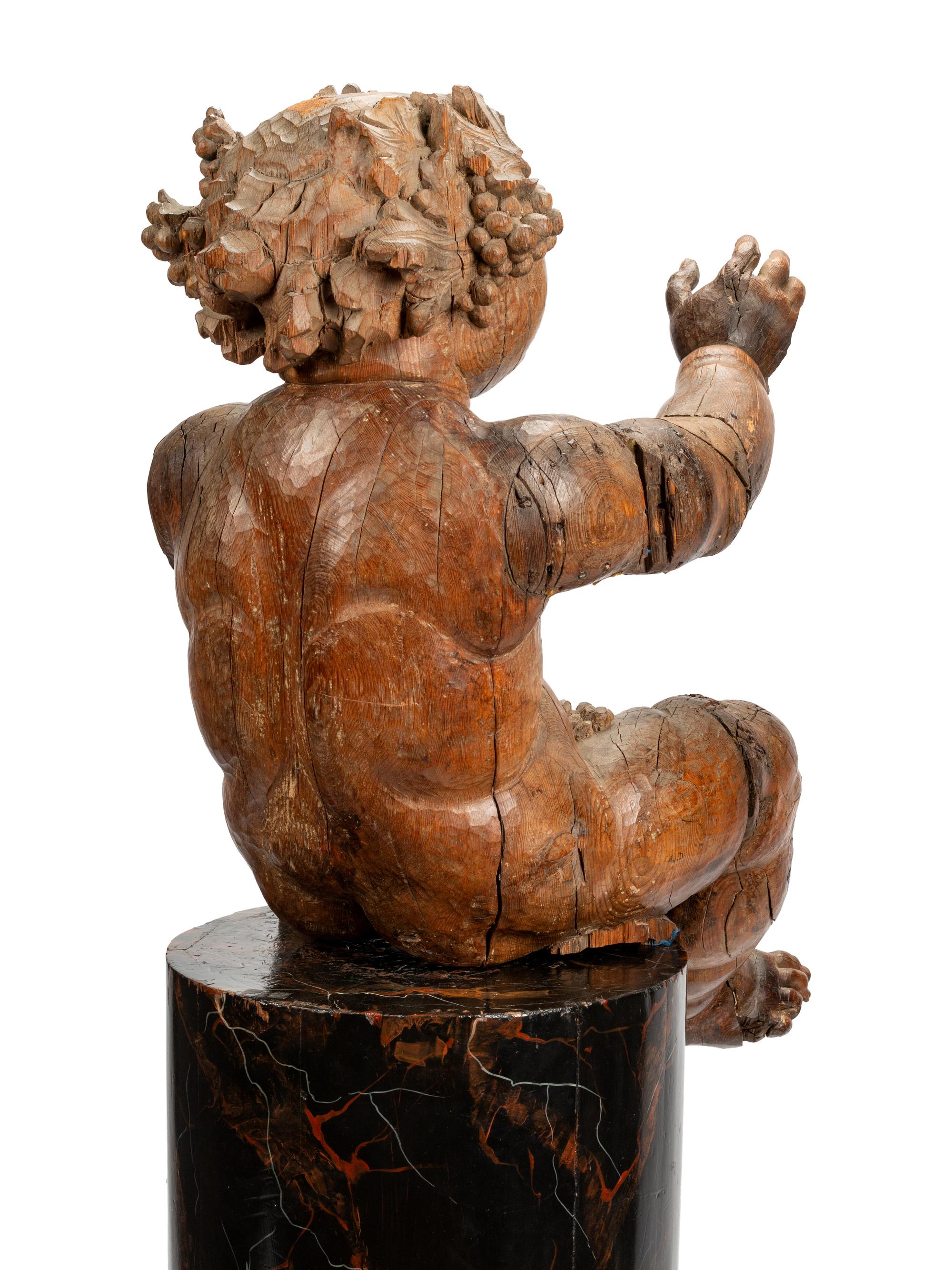 An Italian Carved Wood Figure of Bacchus on a Later Associated Faux Marble Pedestal