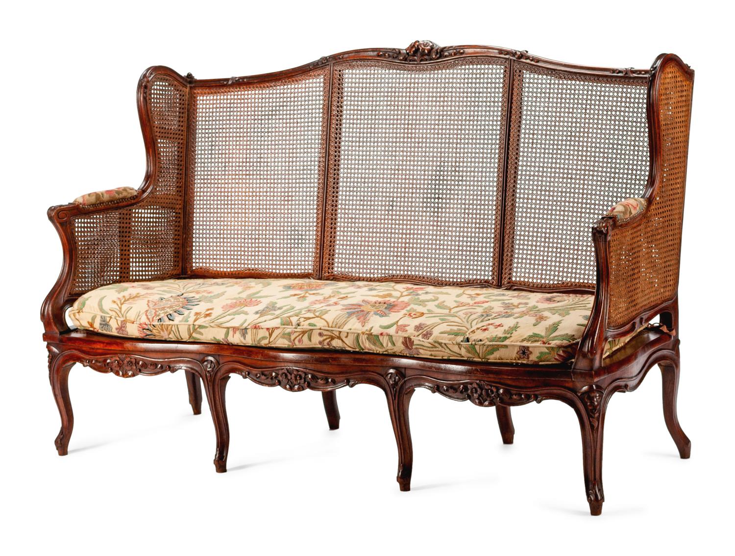 A French Provincial Carved Oak and Caned Settee