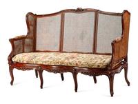 A French Provincial Carved Oak and Caned Settee