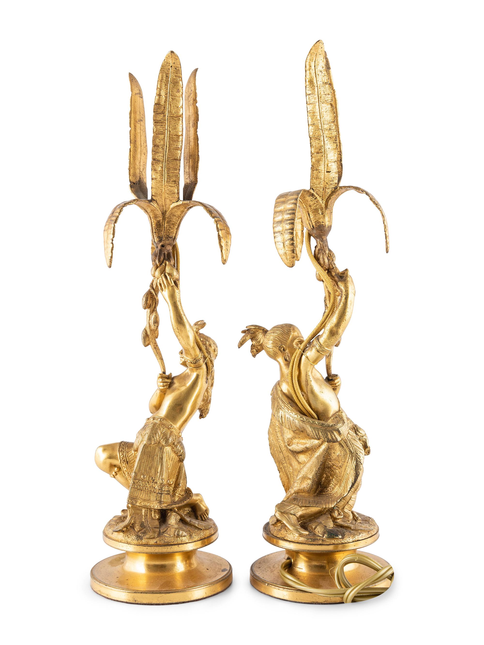A Pair of Figural Gilt Metal Candlesticks