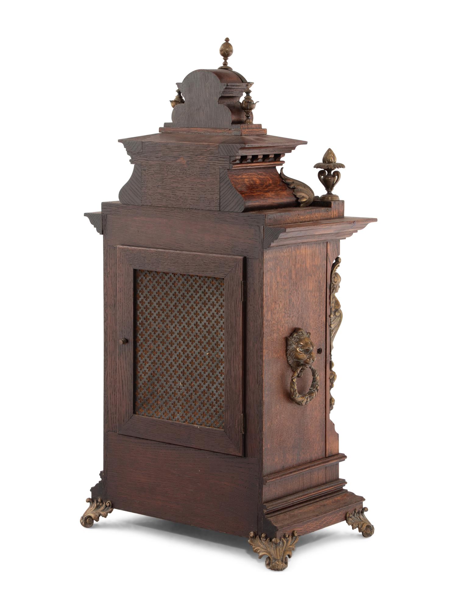 A Lenzkirch Renaissance Revival Gilt Metal Mounted Oak Mantel Clock