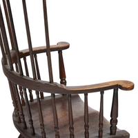A Turned and Black-Painted Comb-Back Windsor Armchair