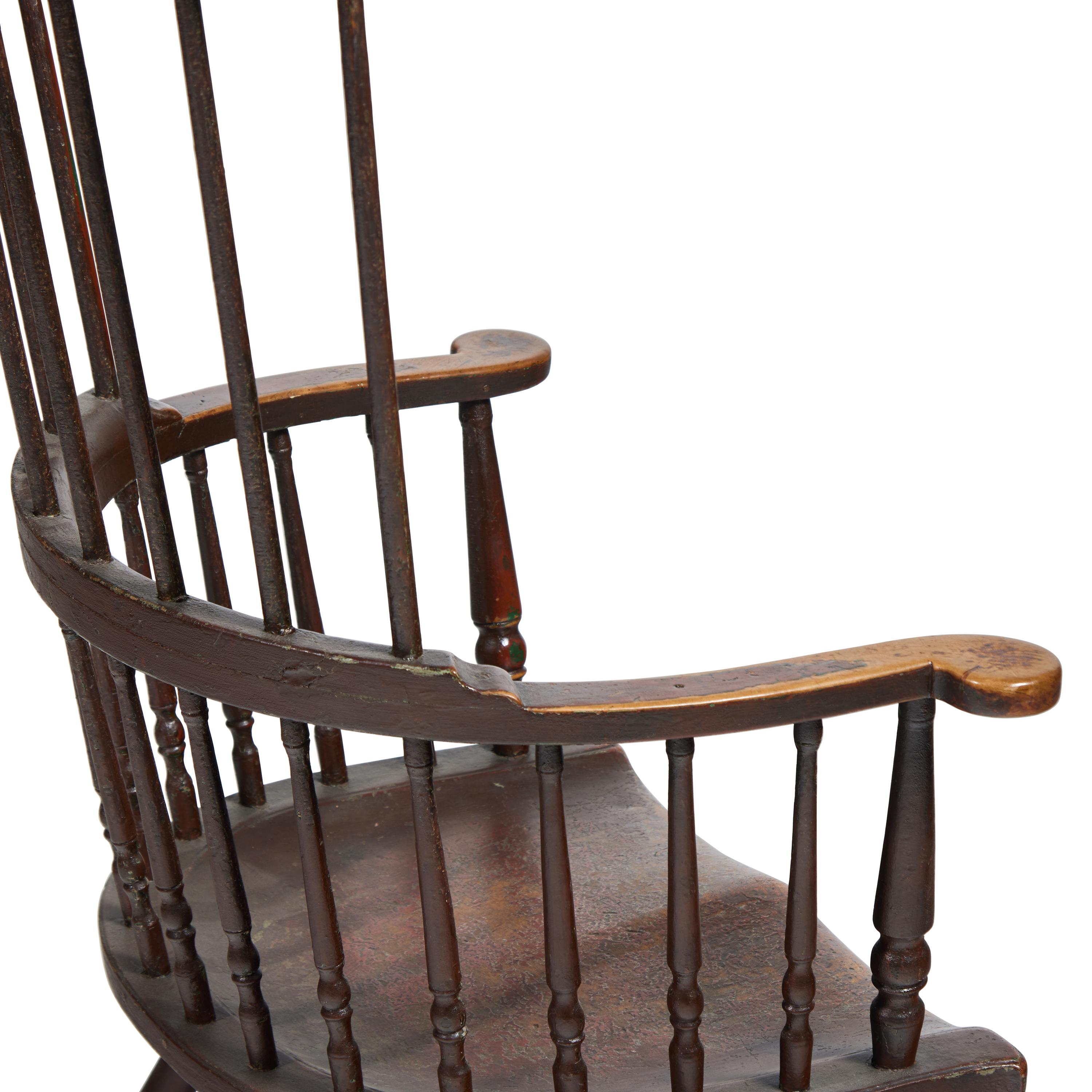 A Turned and Black-Painted Comb-Back Windsor Armchair