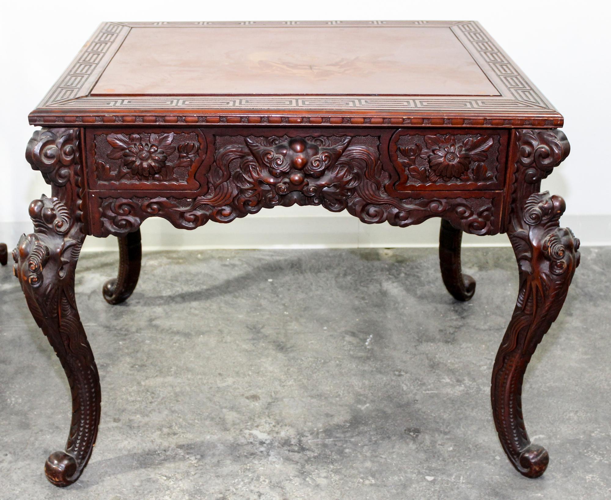 A Chinese Carved Hardwood Game Table Height 30 x width 36 x depth 36 inches.