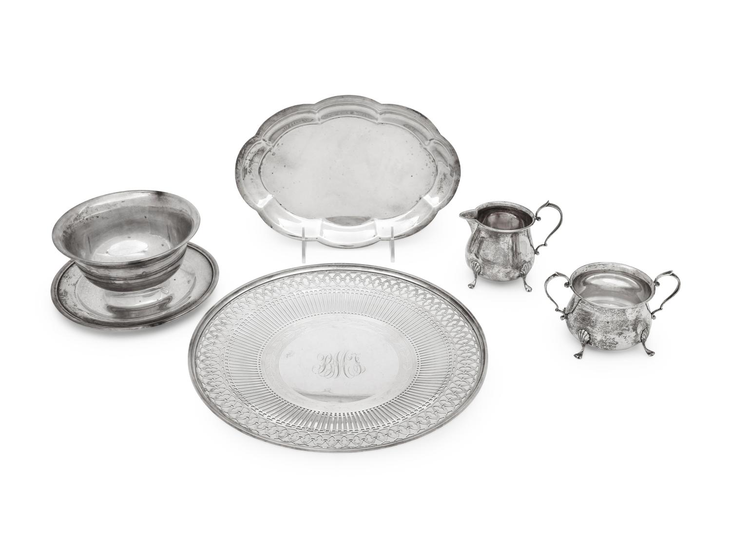 comprising a reticulated cake tray, a scalloped plate, a cream and sugar set, and a bowl with attached underplate.