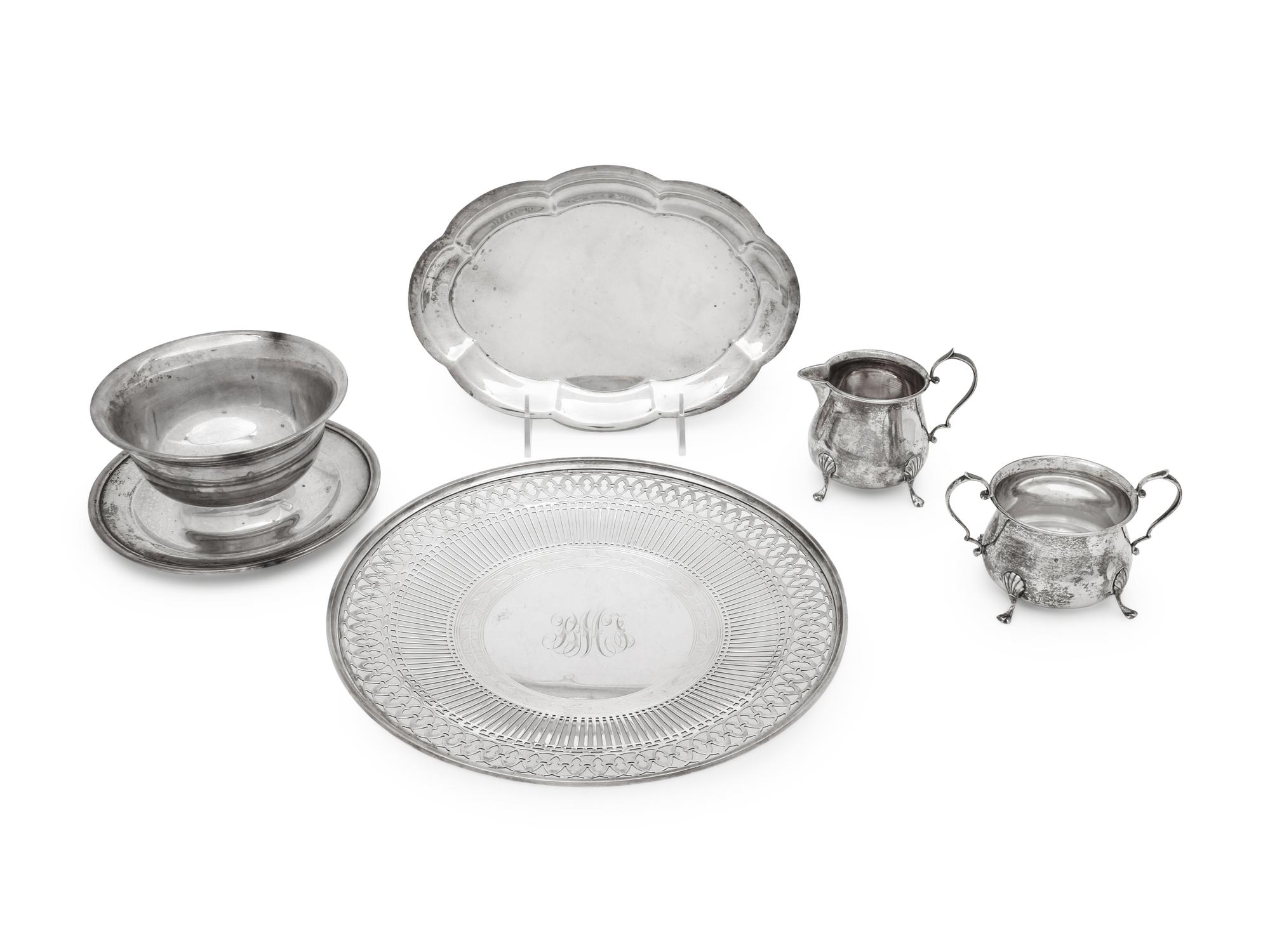 comprising a reticulated cake tray, a scalloped plate, a cream and sugar set, and a bowl with attached underplate.