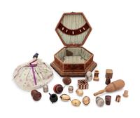 A Velvet-Clad Needlework Box, a Porcelain "Doll" Pin Cushion and a Collection of Thimble Cases