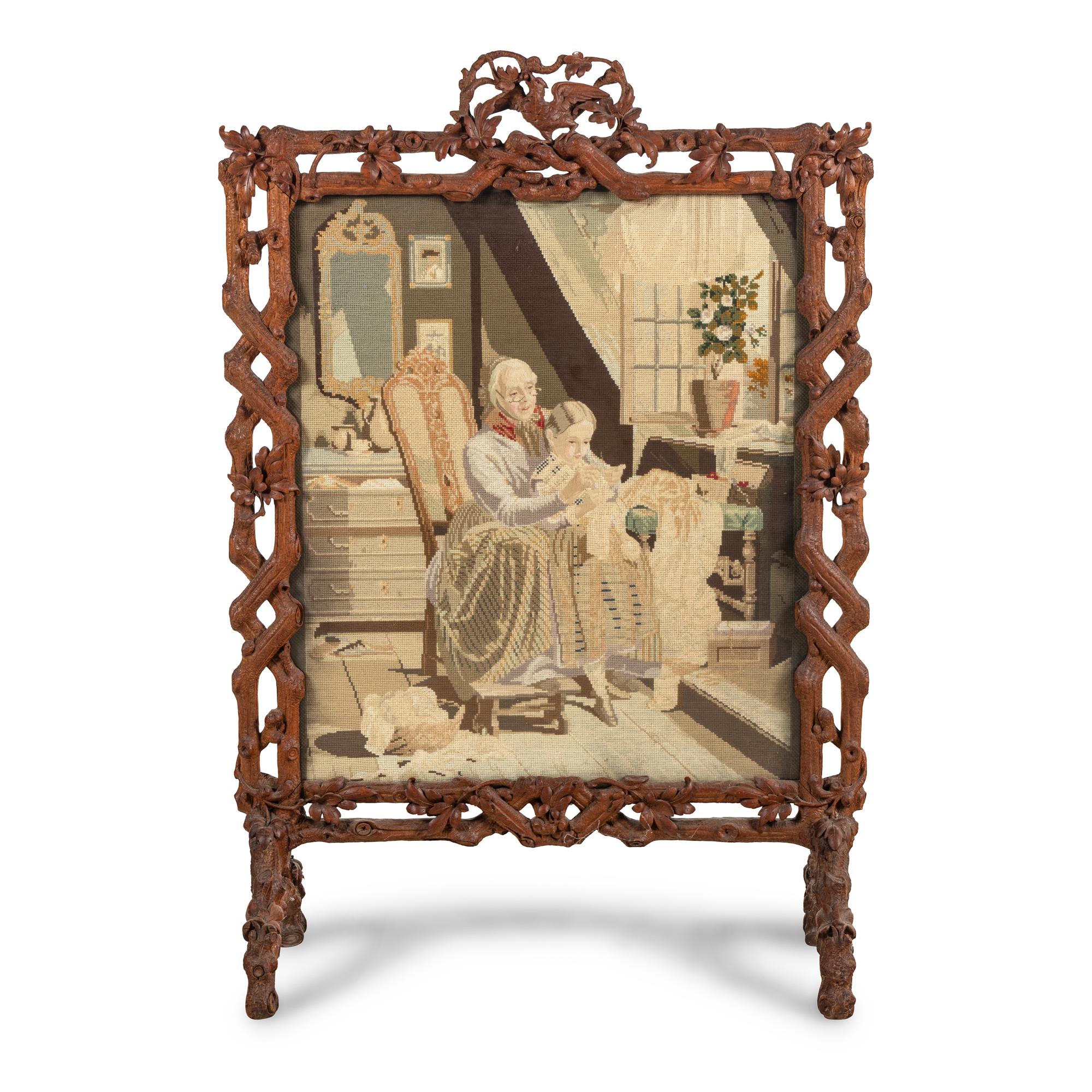 A Swiss "Black Forest" Carved Needlepoint-Inset Firescreen
