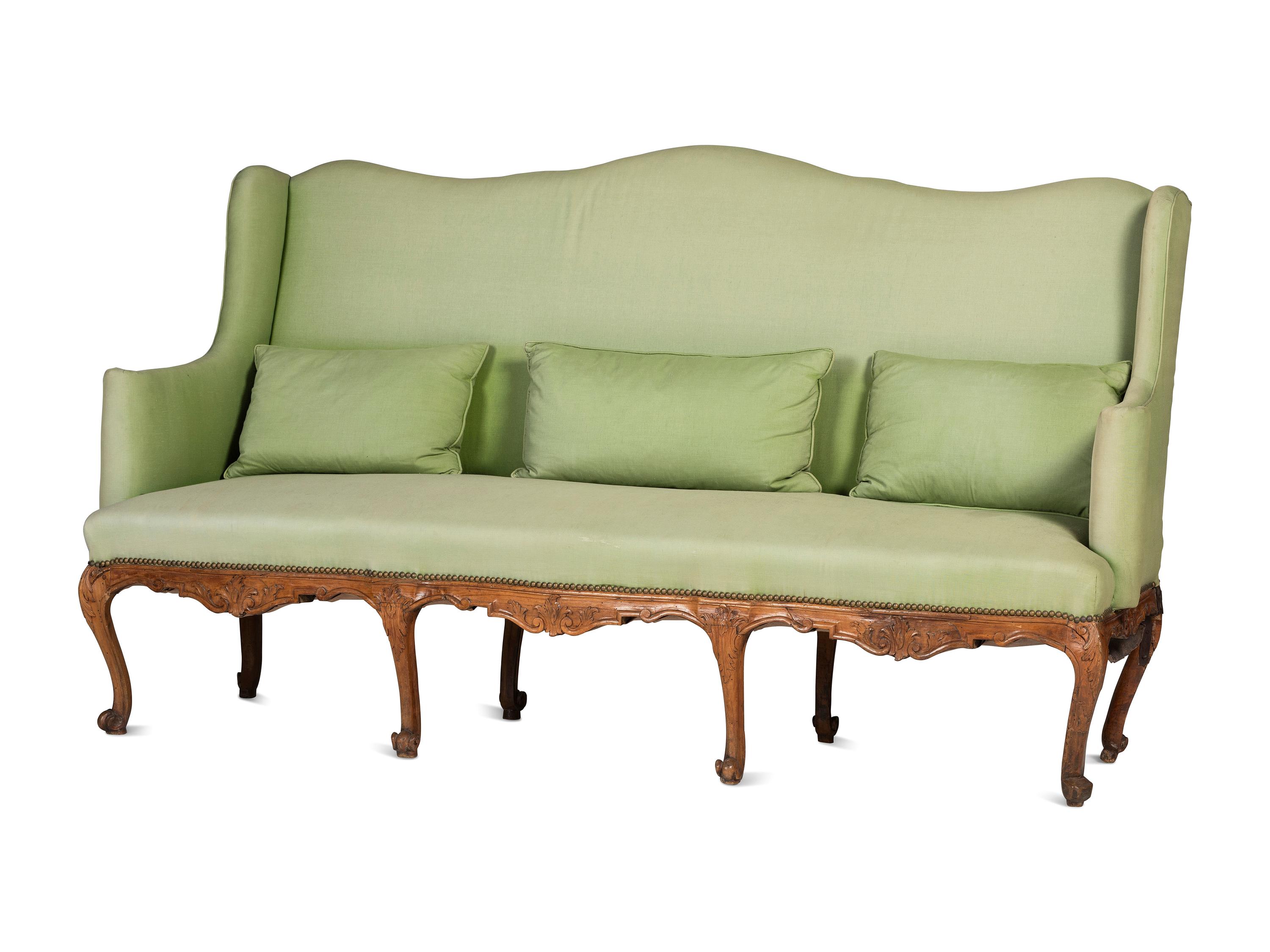 A French Provincial Carved Fruitwood Upholstered High-Back Sofa