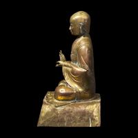 A Gilt Repousse Copper Alloy Figure of a Seated Monk, Probably Dolonor, Inner Mongolia, 18th/19th Century 清中期 銅鎏金上師坐像