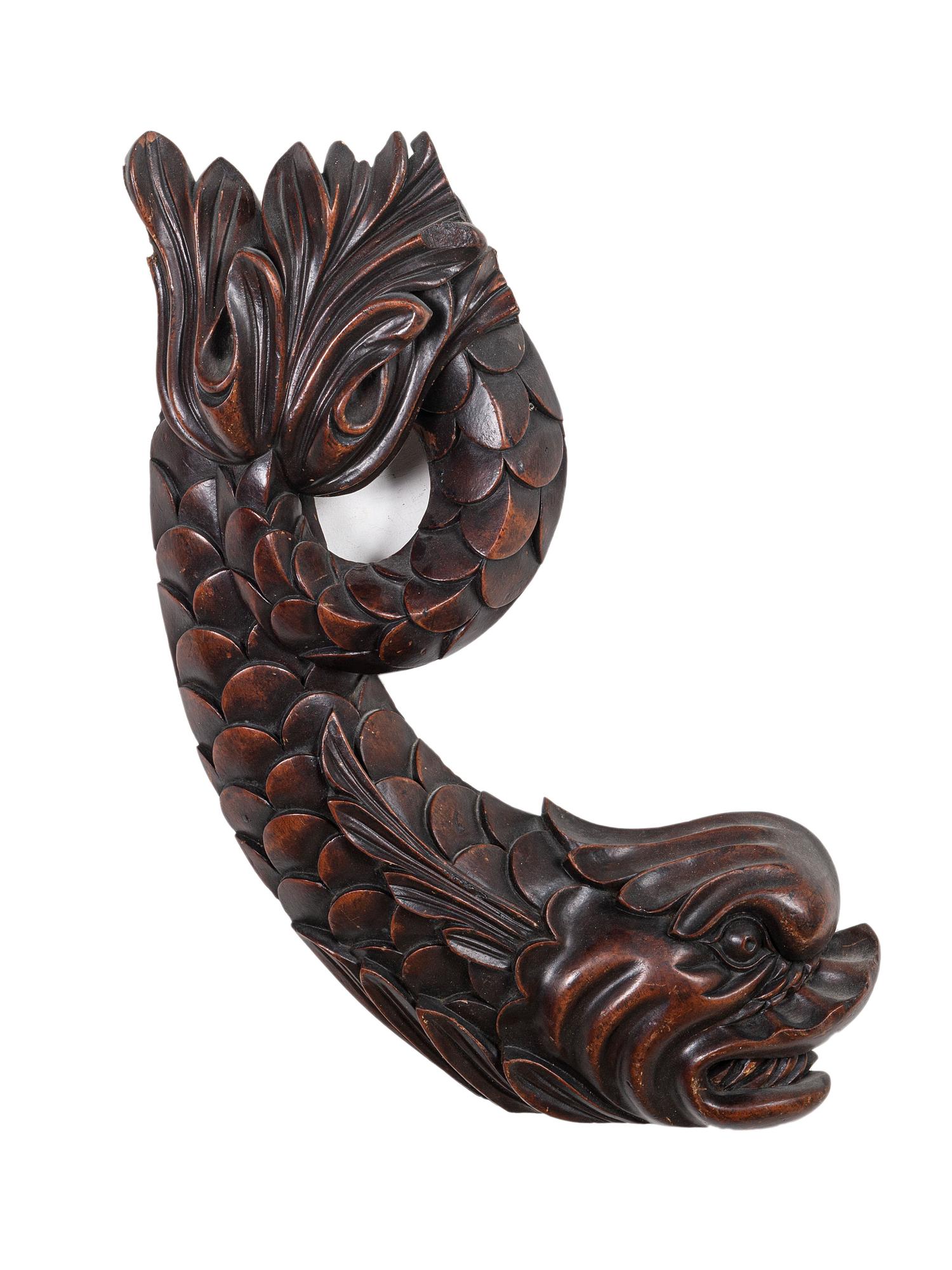 A Pair of Carved Mahogany Dolphin Brackets