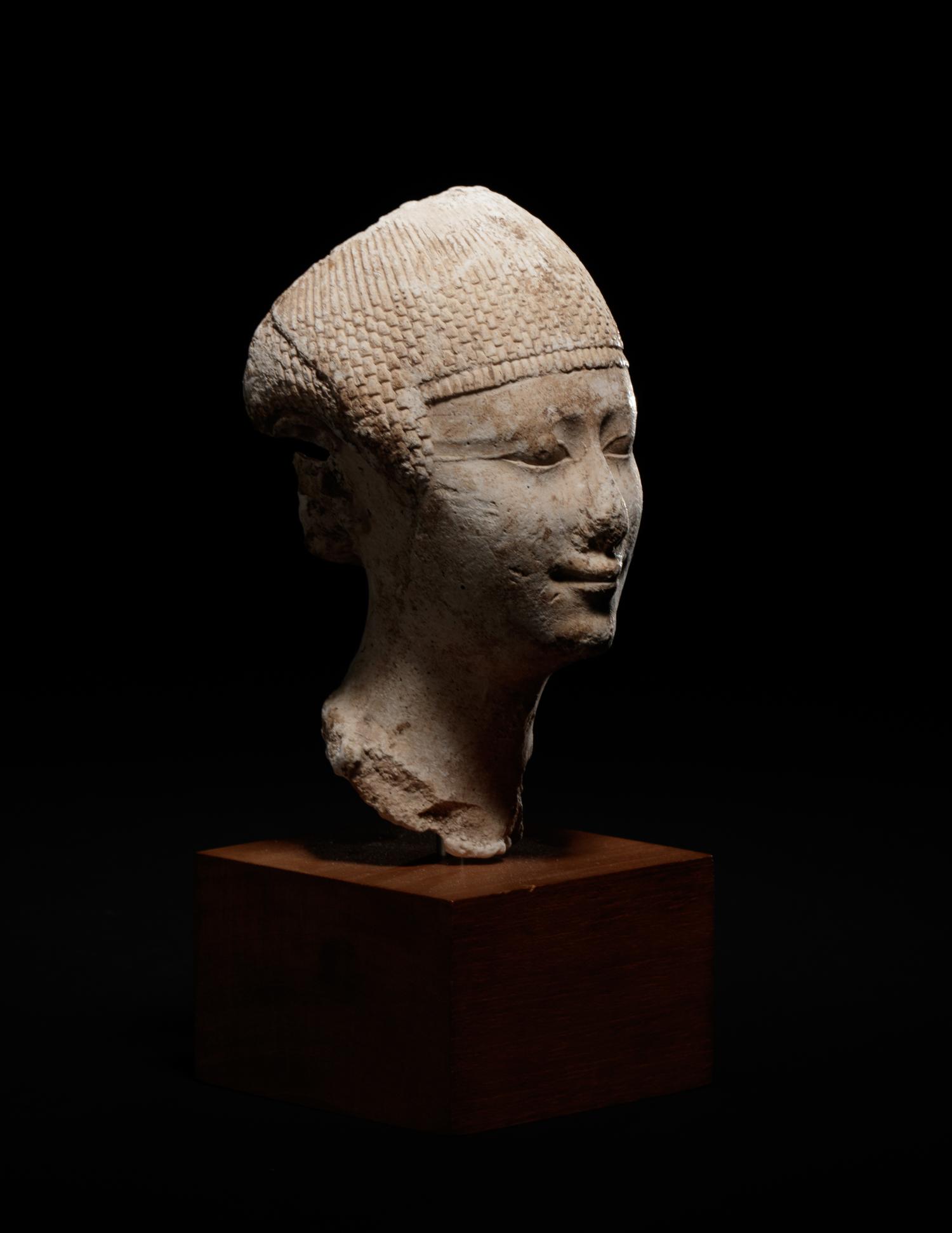 An Egyptian Limestone Head of a Noblewoman