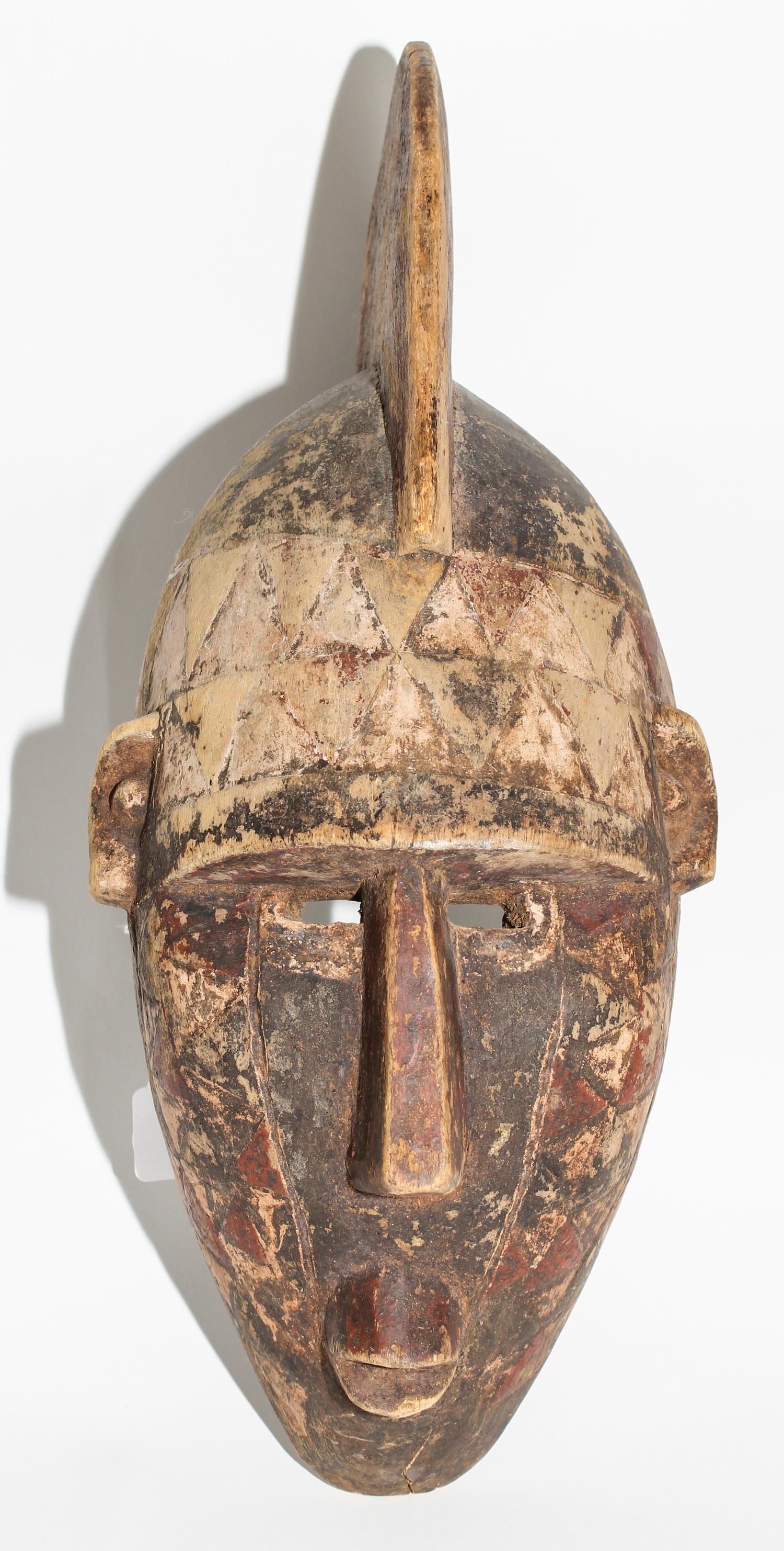A Mossi Painted Helmet Mask. Height 21 inches.