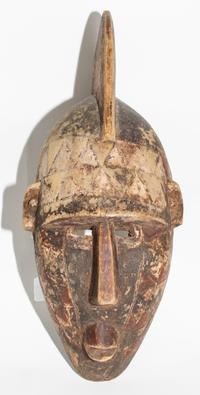 A Mossi Painted Helmet Mask. Height 21 inches.
