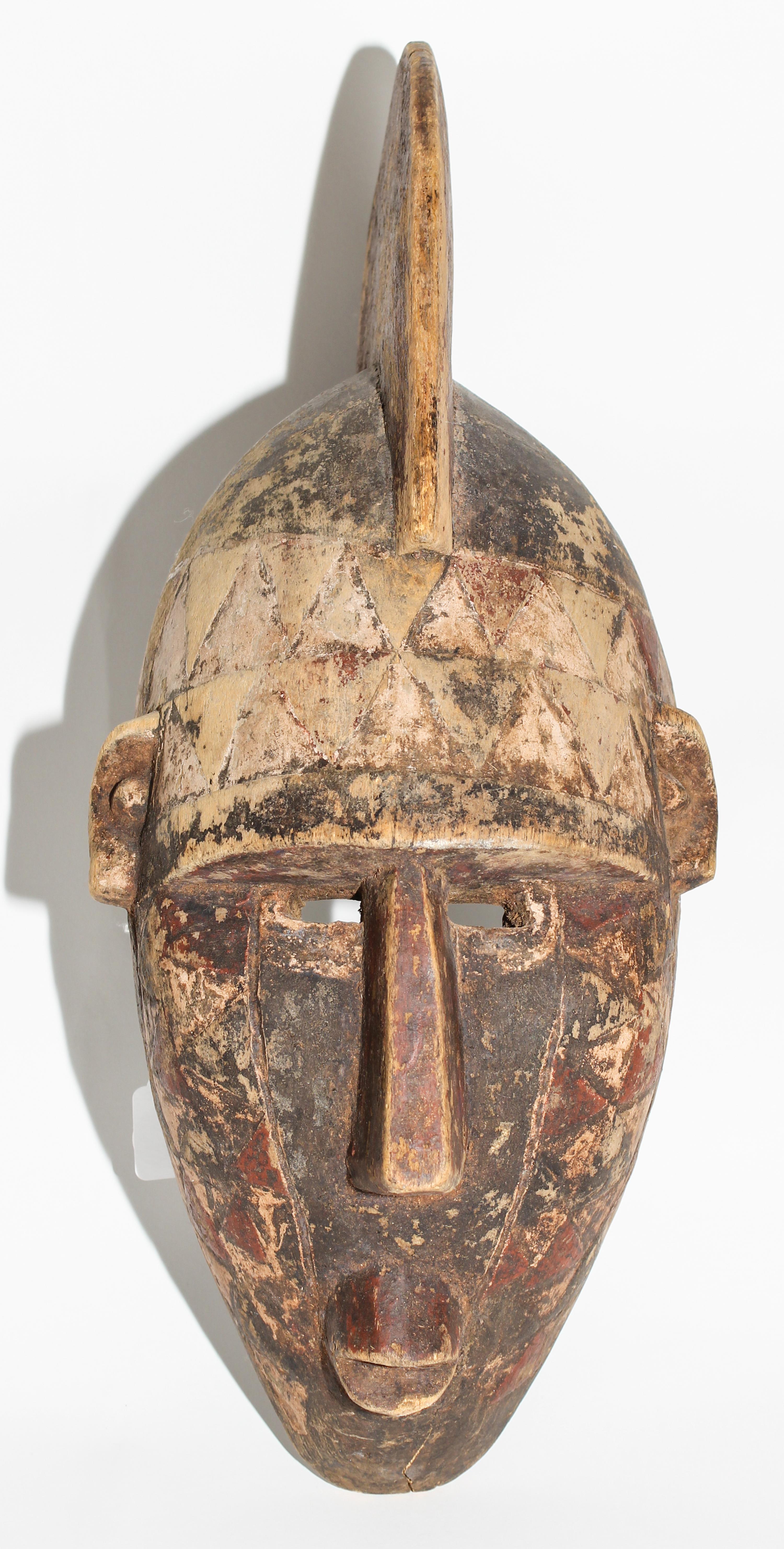A Mossi Painted Helmet Mask. Height 21 inches.