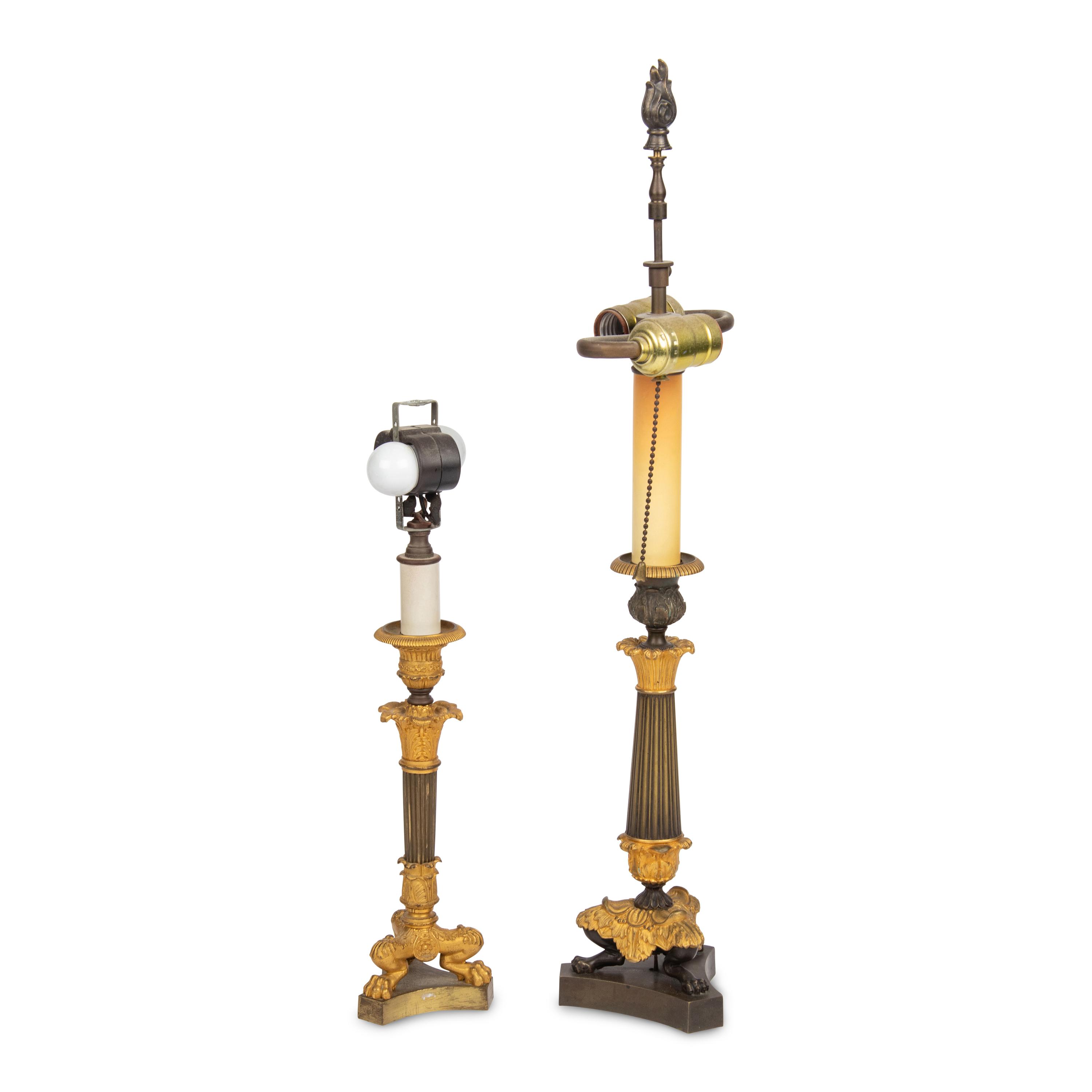 A Group of Two French Empire Style Parcel-Gilt Bronze Candlesticks Mounted as Lamps