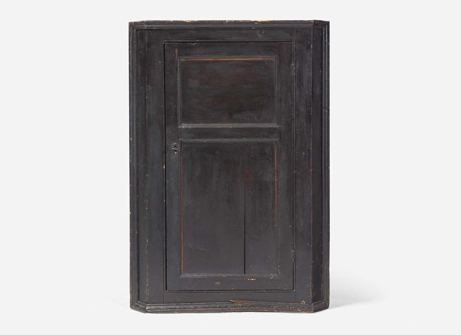 A Chippendale black-painted pine hanging corner cupboard, late 18th century