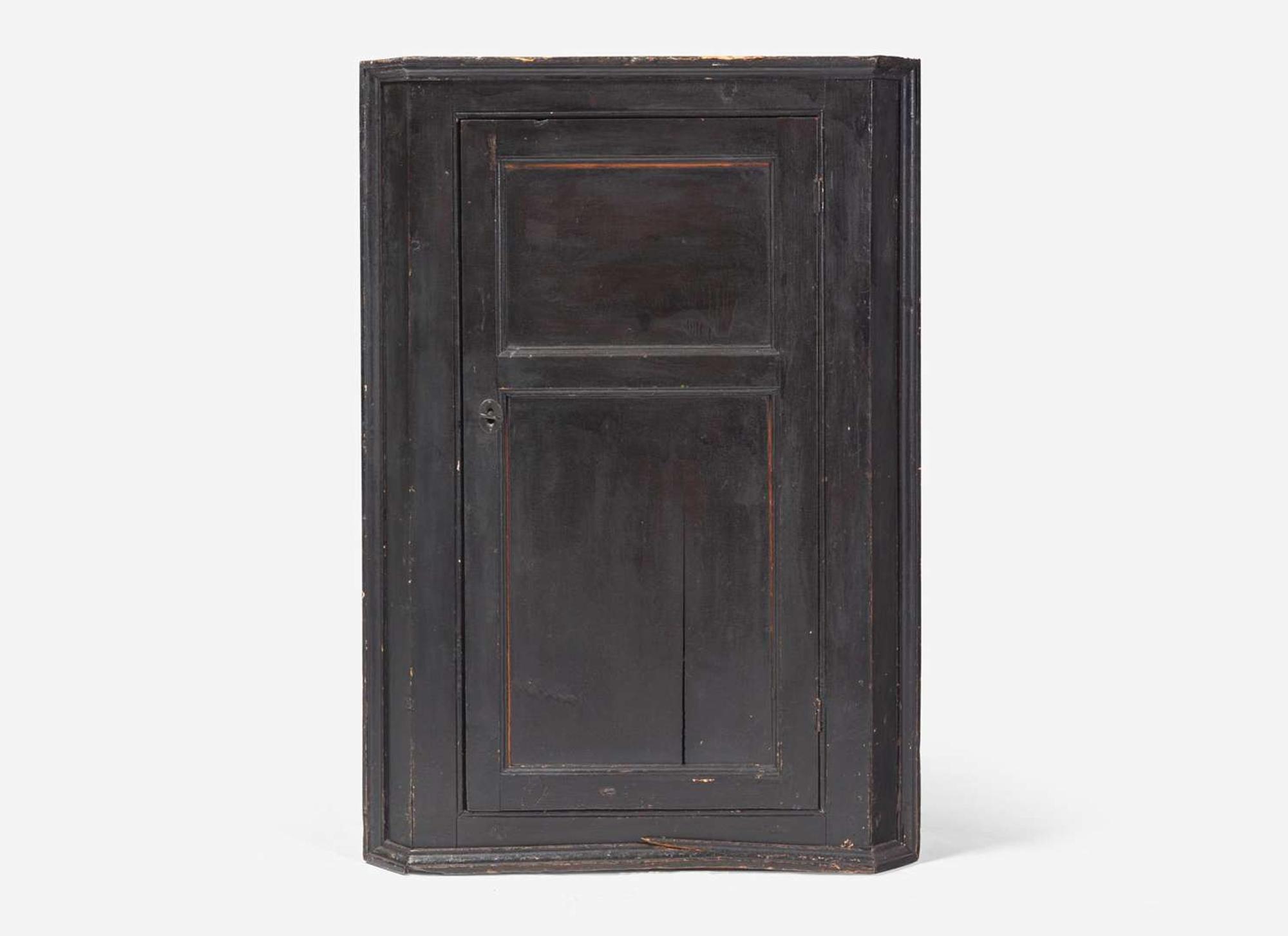 A Chippendale black-painted pine hanging corner cupboard, late 18th century