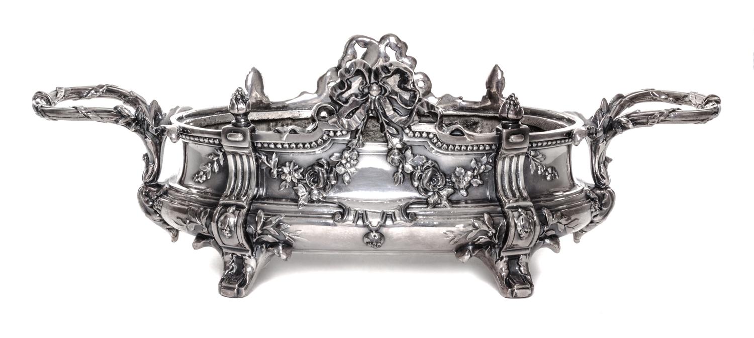A Neoclassical Silver-Plate Jardiniere, 19th/20th Century, of oval handled form with ribbon tied festoon and foliate decoration.