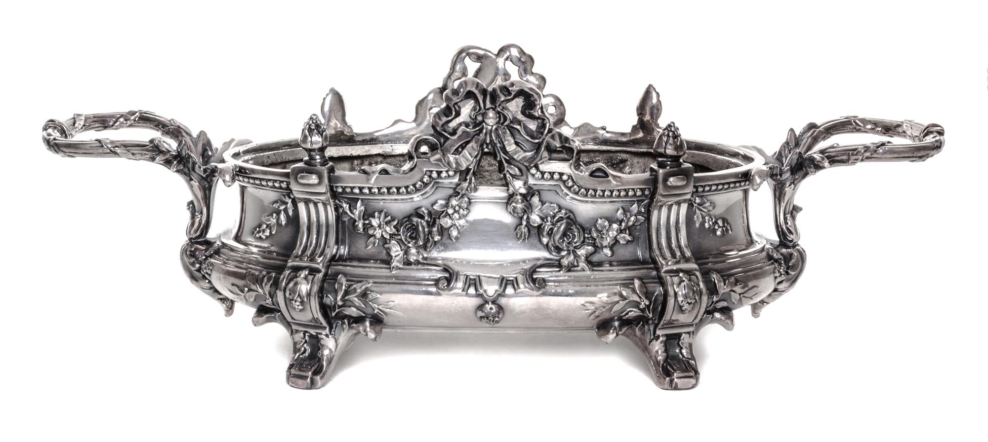 A Neoclassical Silver-Plate Jardiniere, 19th/20th Century, of oval handled form with ribbon tied festoon and foliate decoration.