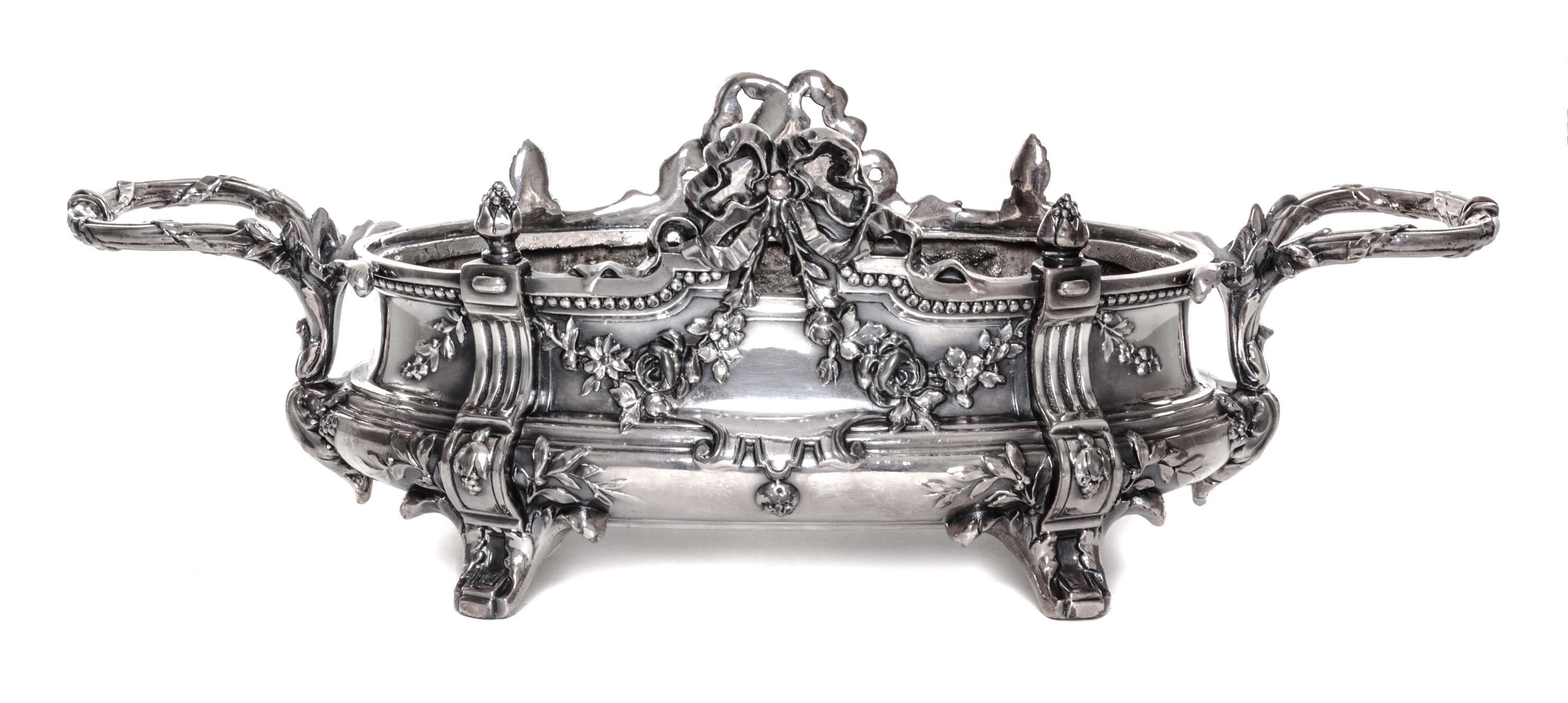 A Neoclassical Silver-Plate Jardiniere, 19th/20th Century, of oval handled form with ribbon tied festoon and foliate decoration.