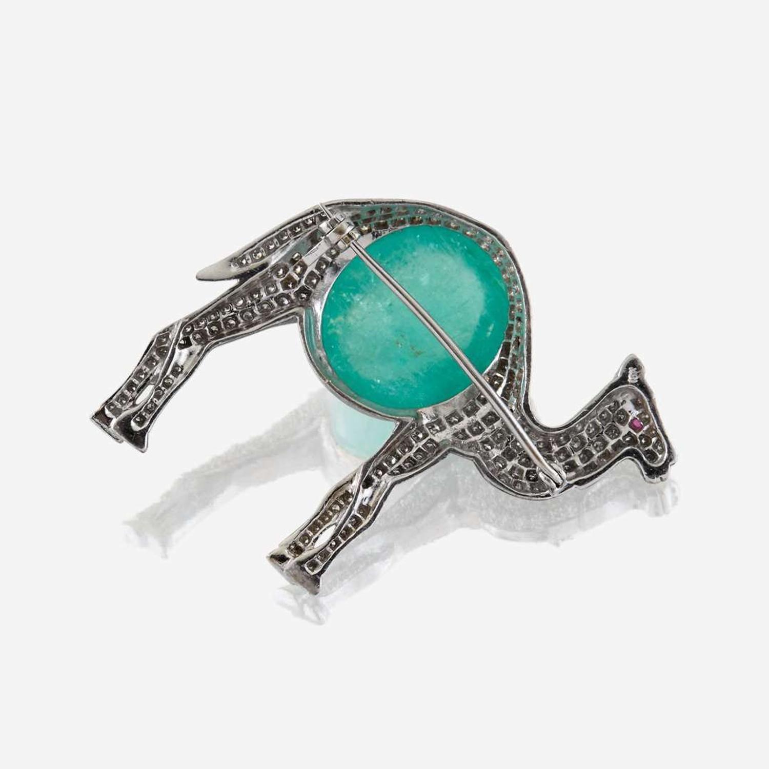 An emerald, diamond, and eighteen karat white gold brooch