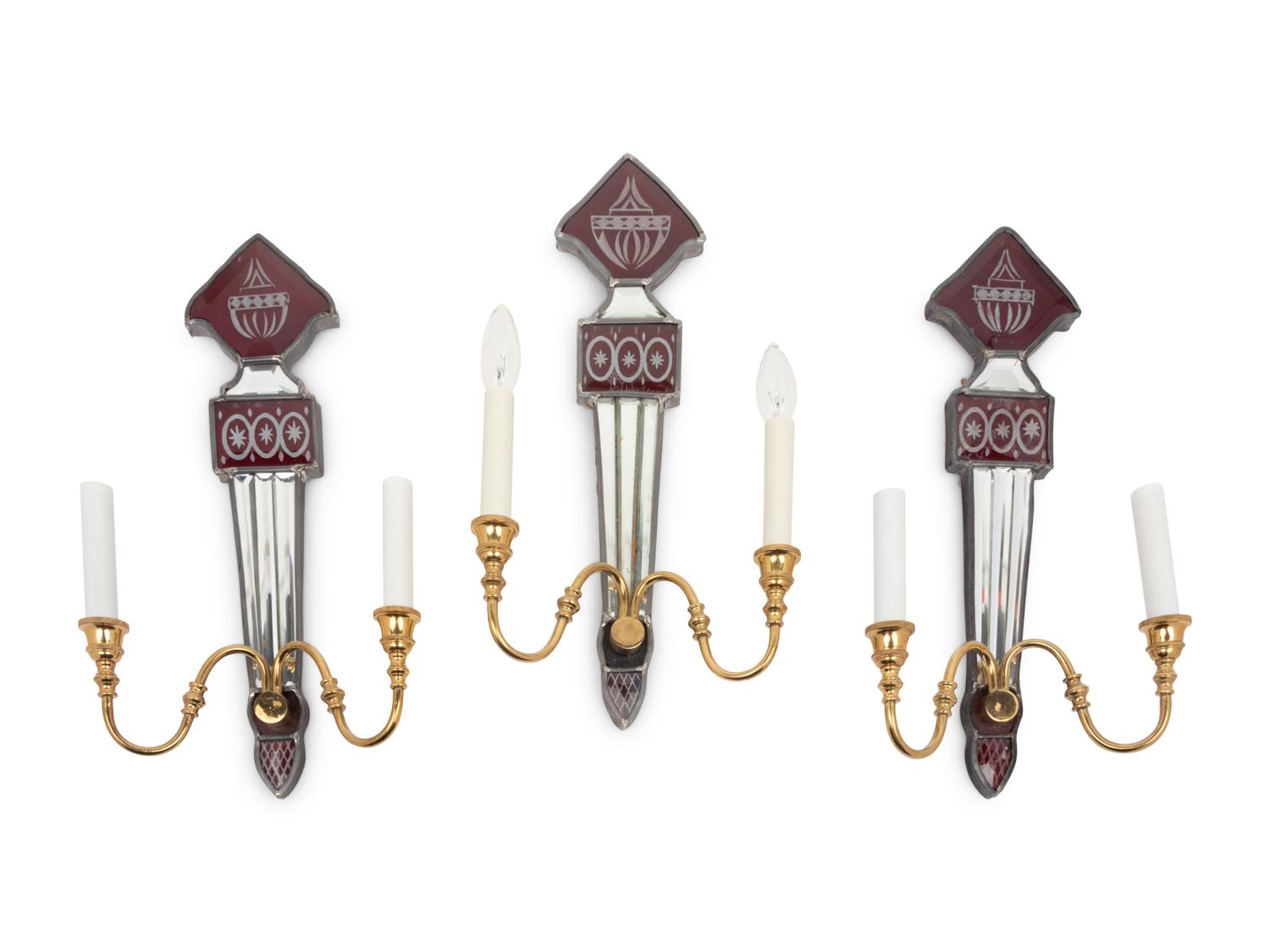 A Set of Three Mirrored, Red Glass and Brass Two-Light Sconces
