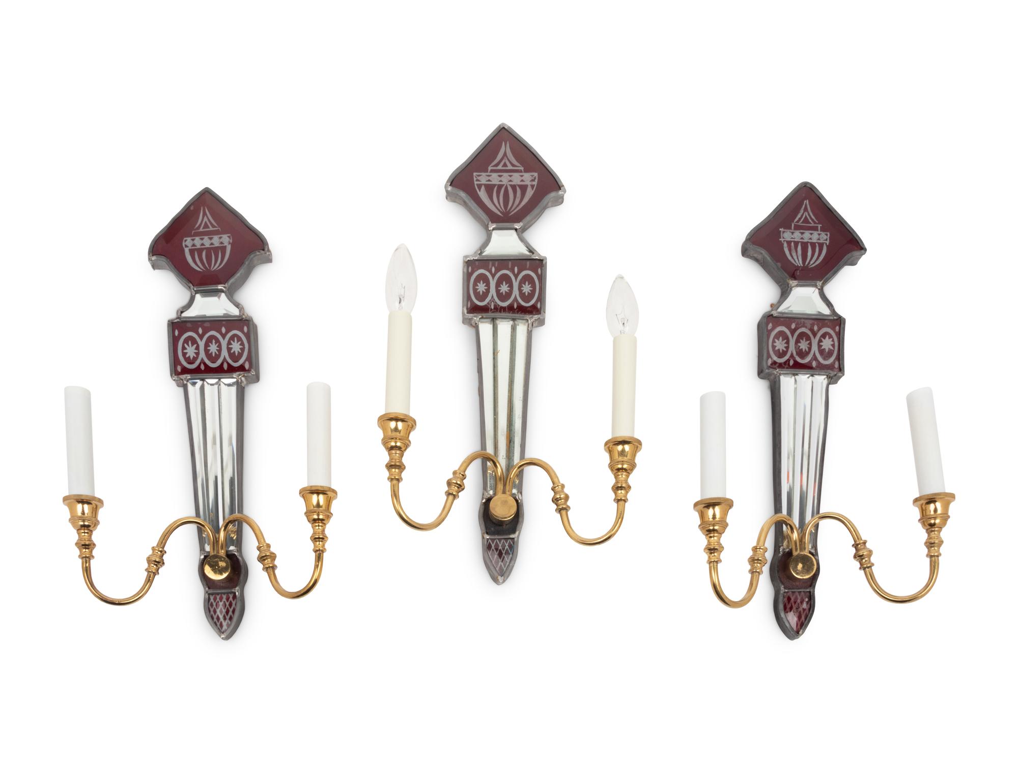 A Set of Three Mirrored, Red Glass and Brass Two-Light Sconces