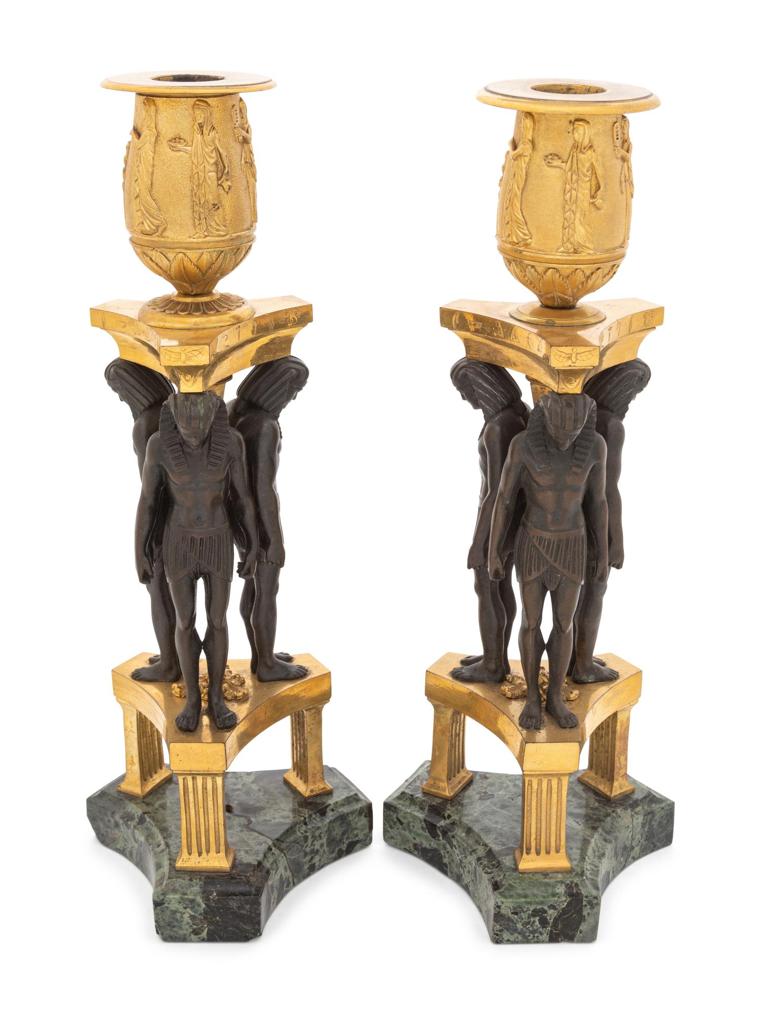 A Pair of French Egyptian Revival Bronze and Marble Candlesticks
