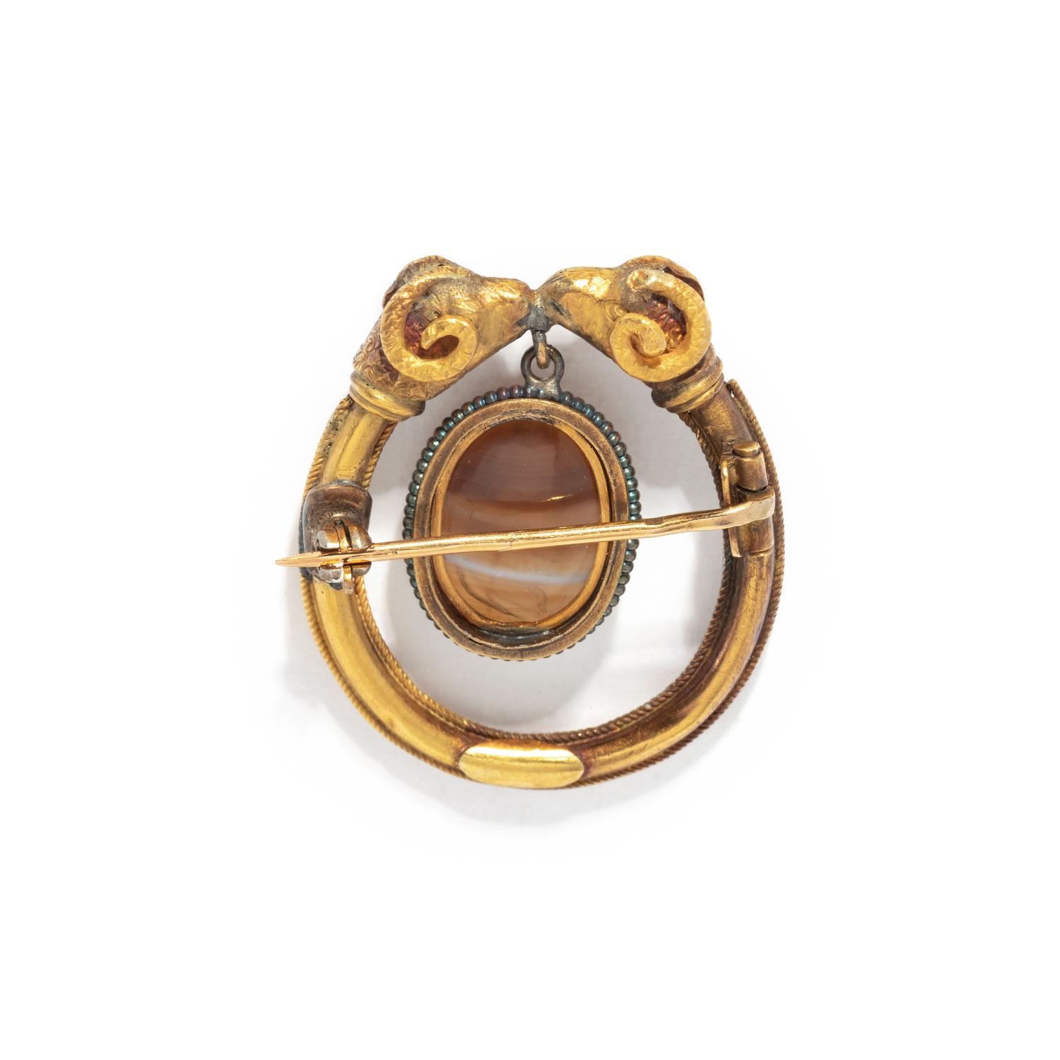 A Roman Banded Agate Intaglio with the God Apollo — Set in a gold brooch with rams