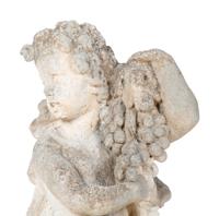 A Cast Stone Figure of Cherub Holding Grapes — 20TH CENTURY