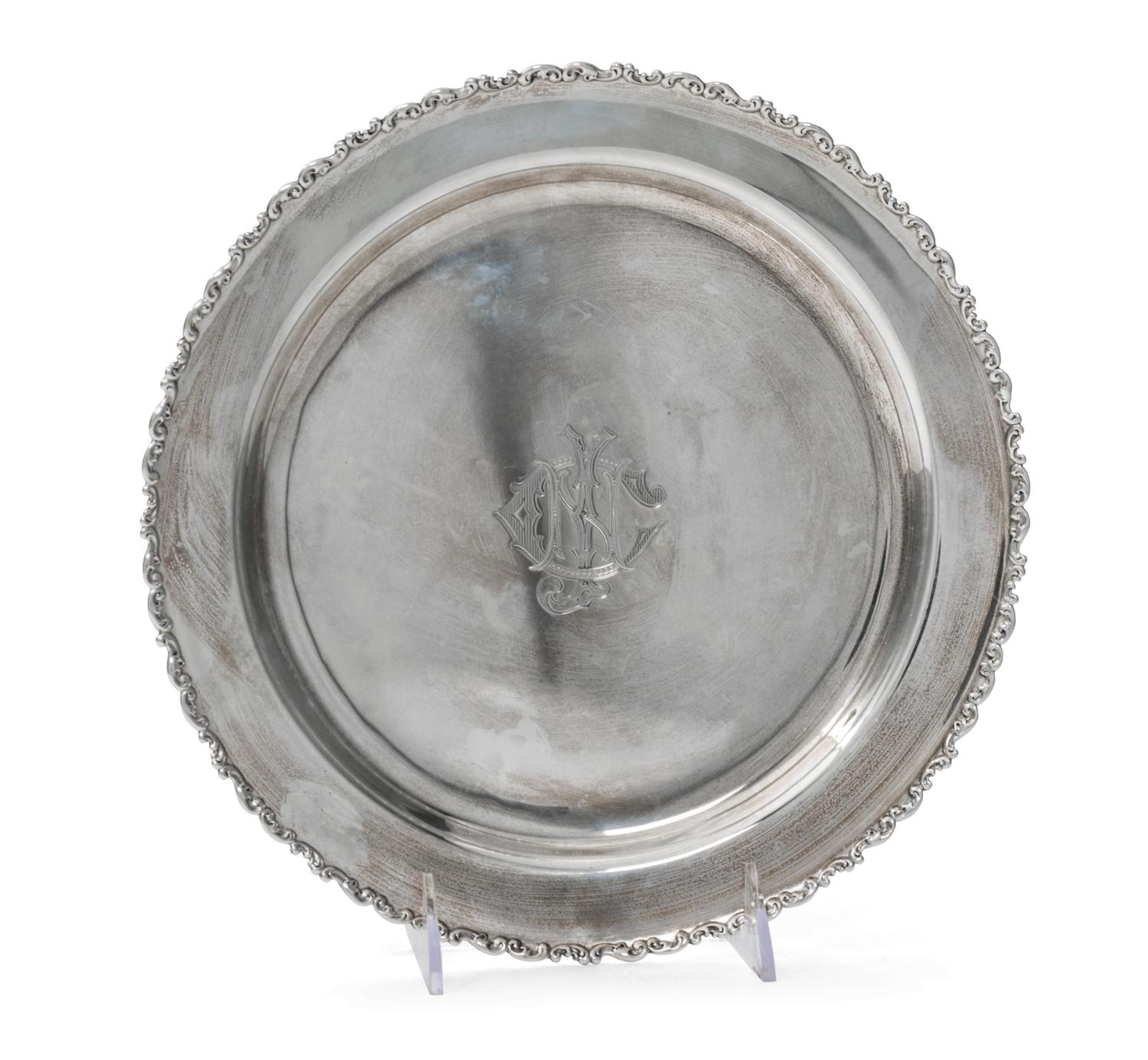 An American Silver Tray, Whiting Manufacturing Co., New York, NY, of circular form with an applied foliate scroll border, centered with