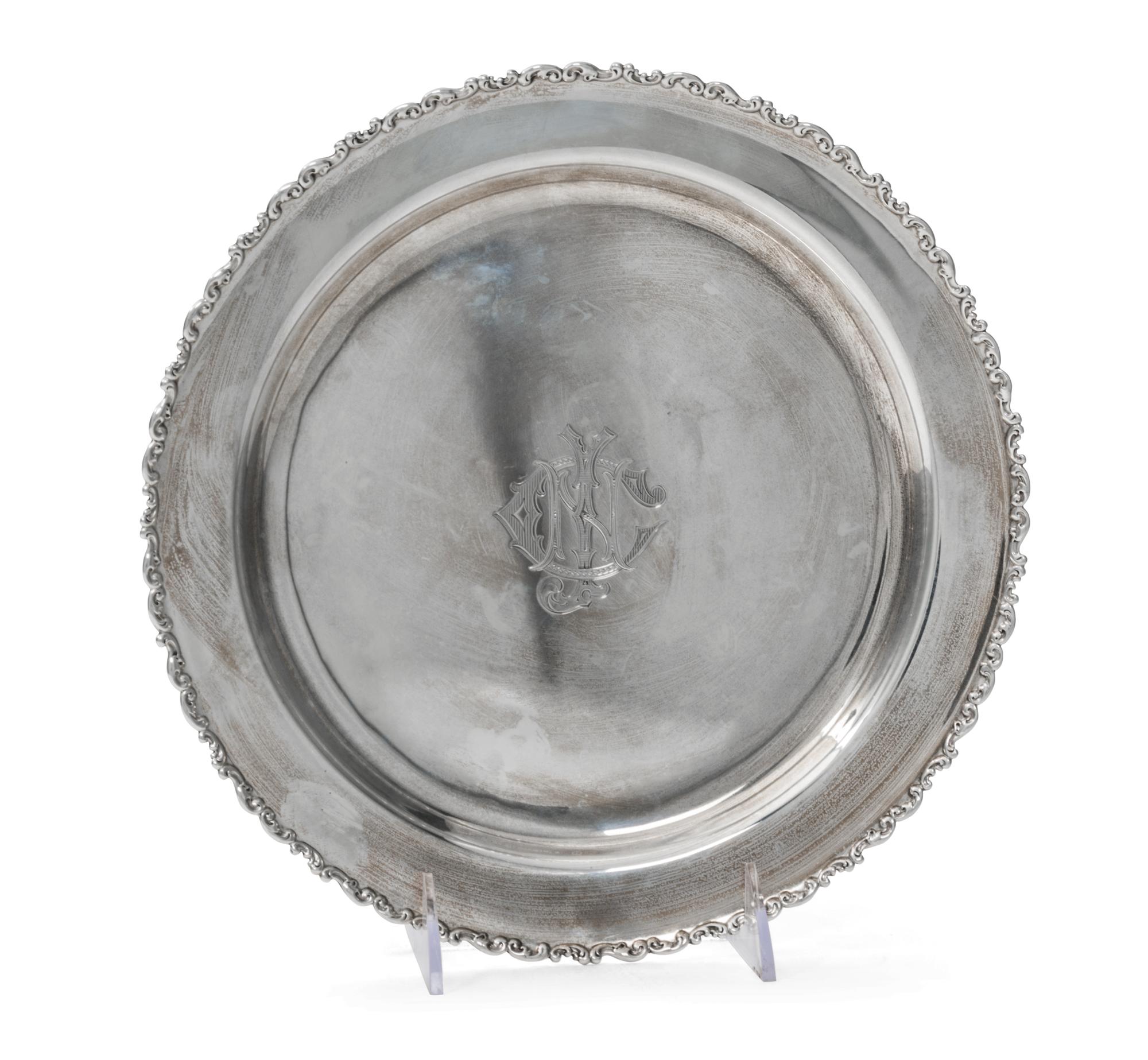 An American Silver Tray, Whiting Manufacturing Co., New York, NY, of circular form with an applied foliate scroll border, centered with