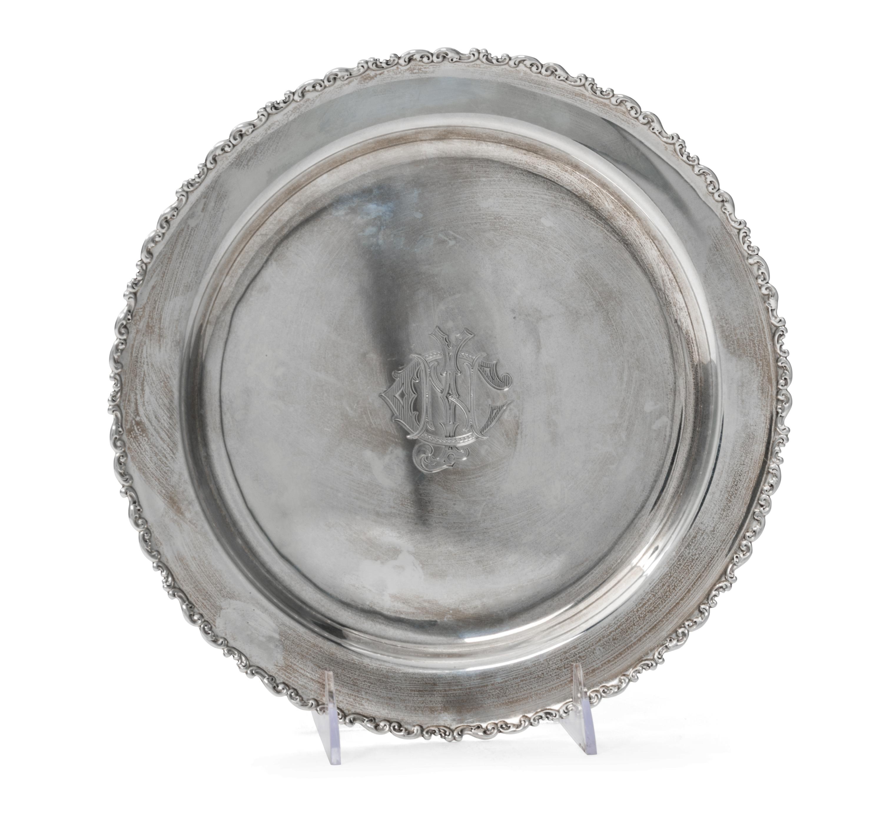 An American Silver Tray, Whiting Manufacturing Co., New York, NY, of circular form with an applied foliate scroll border, centered with