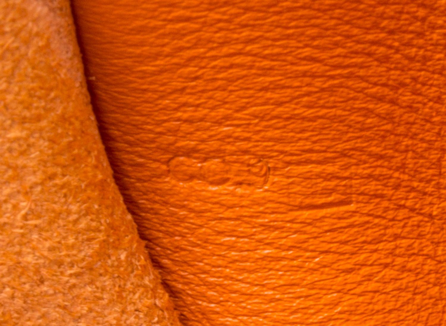 An Hermes Orange Leather Passport Pouch, 7" x 8" x 1".