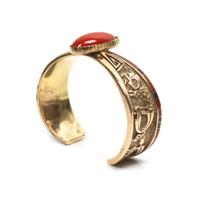An Isleta/ Navajo Gold, Coral and Lapis Bracelet, Attributed to Andy Lee Kirk Length 4 3/4 x opening 1 x width 7/8 inches.