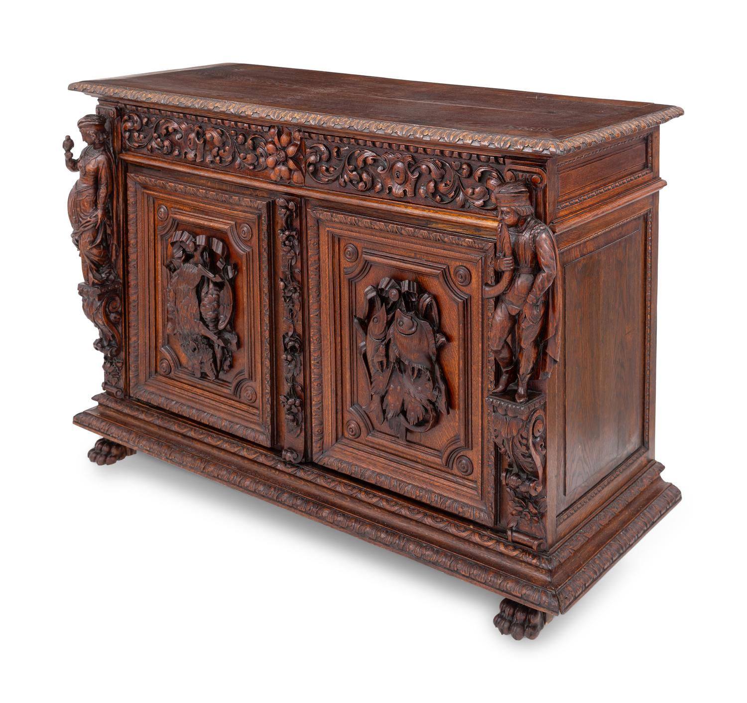 A Swiss Black Forest Carved Hunt Cabinet