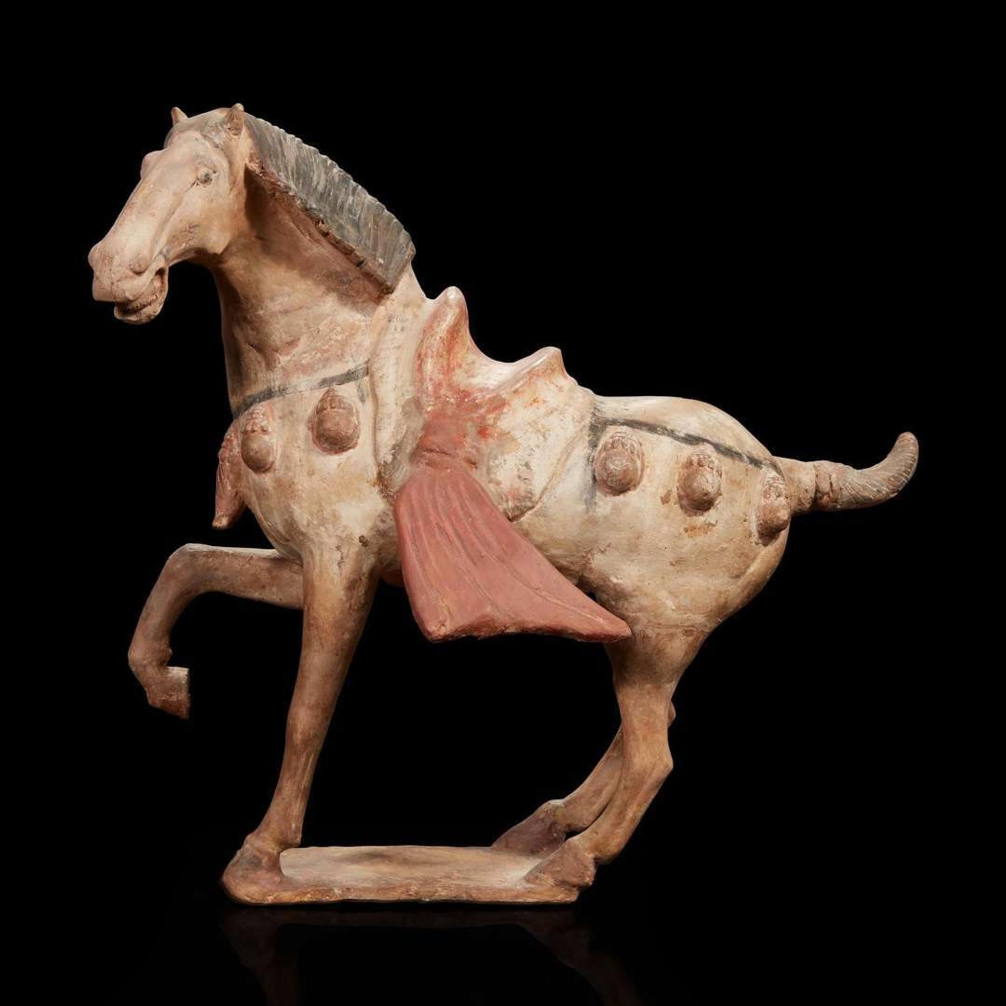 A Chinese painted pottery figure of a prancing horse Tang dynasty