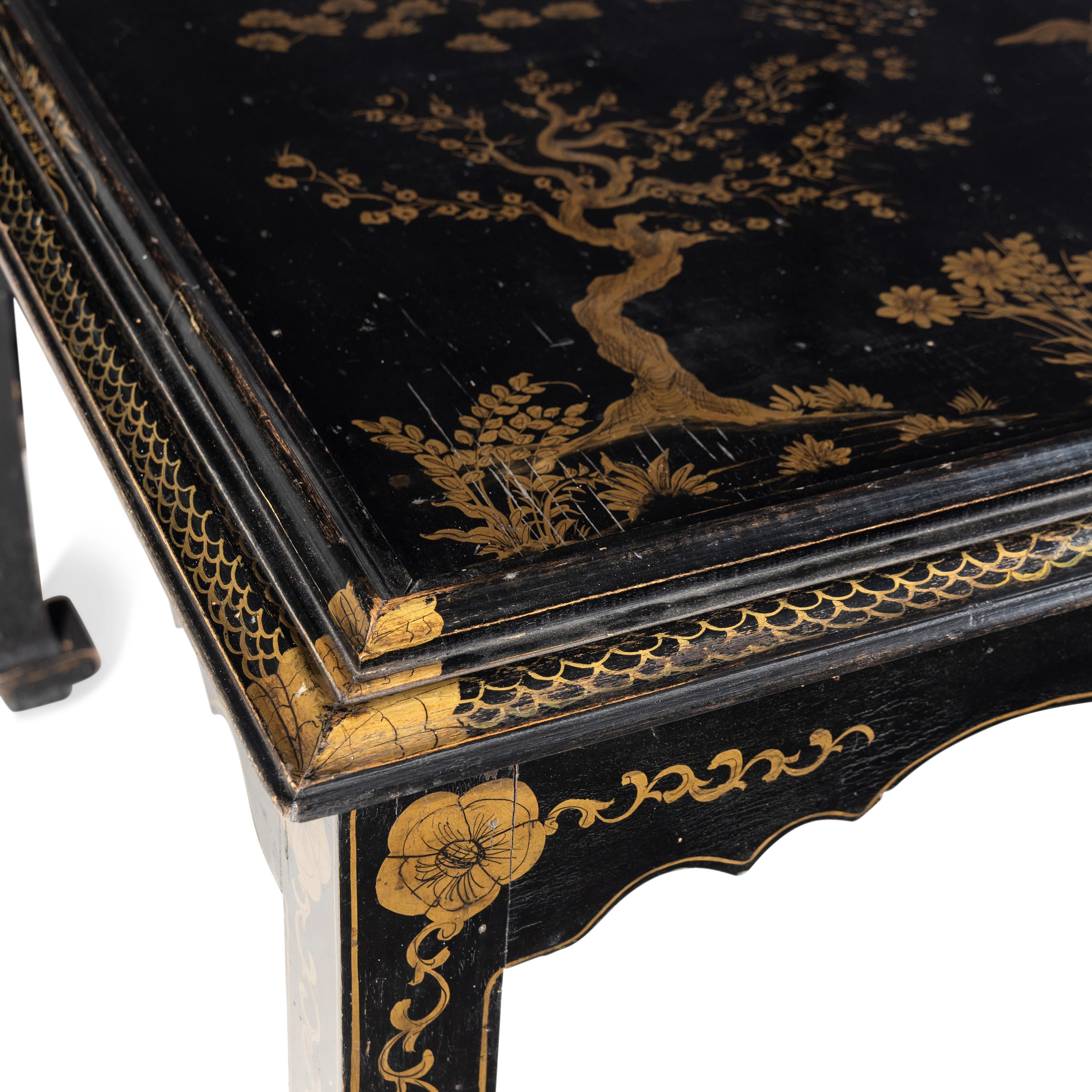 A Modern Parcel Gilt and Black Lacquered Chinoiserie Decorated Scroll Foot Table