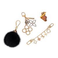 LOUIS VUITTON, GROUP OF FOUR BAG CHARMS