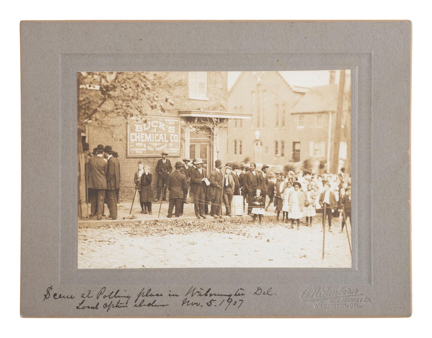[VOTING RIGHTS]. SANBORN, A.N., photographer. Outdoor scene featuring African Americans gathered at a polling place in Wilmington, Delaware, 5 November 1907.