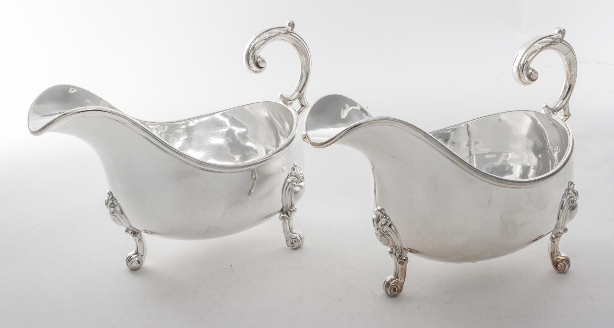 A Pair of English Silver-plate Sauce Boats, Elkington & Co., Birmingham, 20th Century, of typical boat form raised on three scroll feet