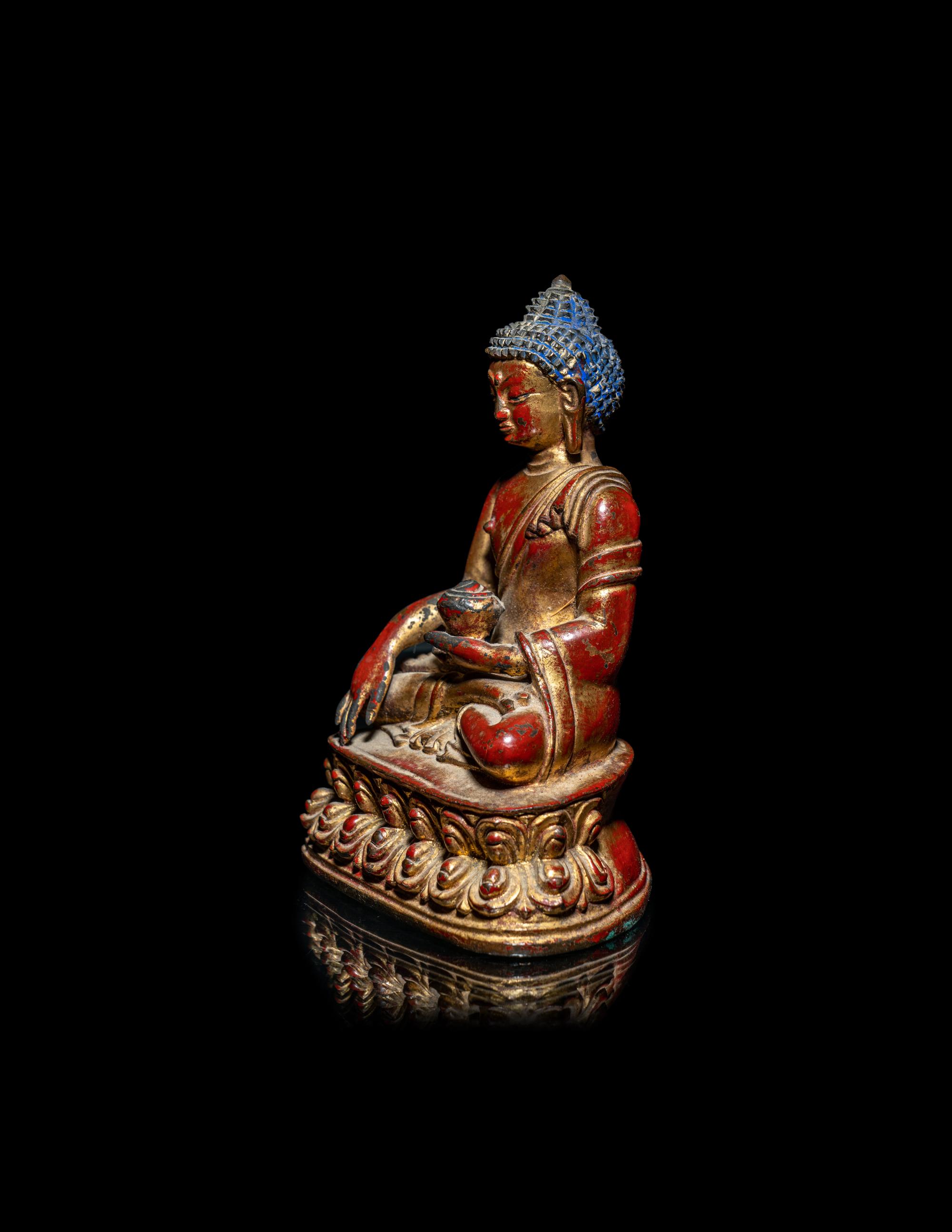 A Tibetan/Nepalese Gilt and Red Lacquered Bronze Figure of Buddha