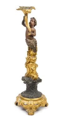 A French Gilt and Patinated Bronze Figural Candlestick Height 20 1/4 inches. — CIRCA 1900