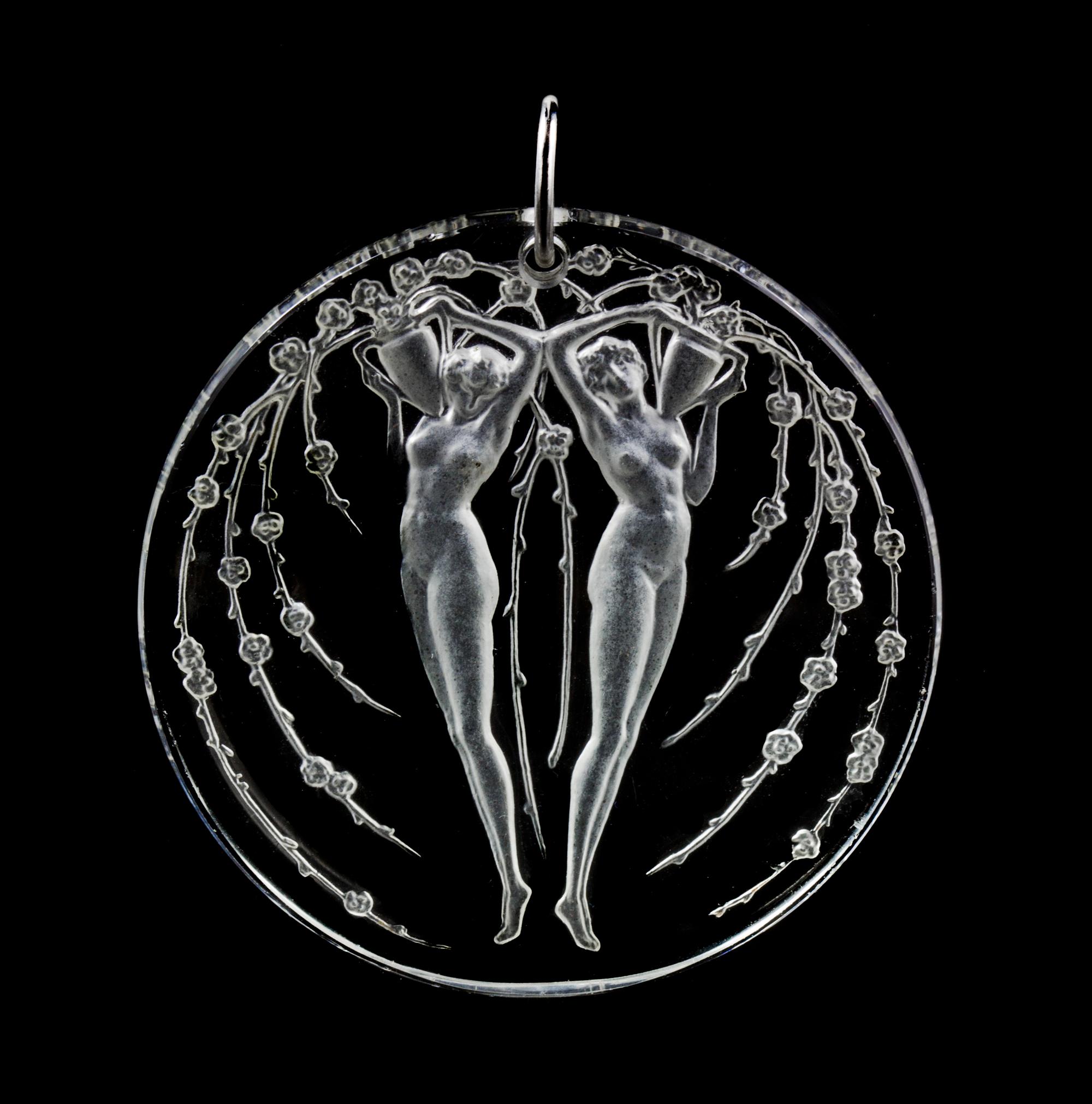 A Molded Glass and Platinum 'Deux Figurines Et Fleurs' Pendant, Rene Lalique,