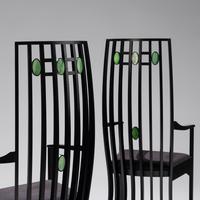 Pair of Cassina e bonized armchairs with slag glass inserts