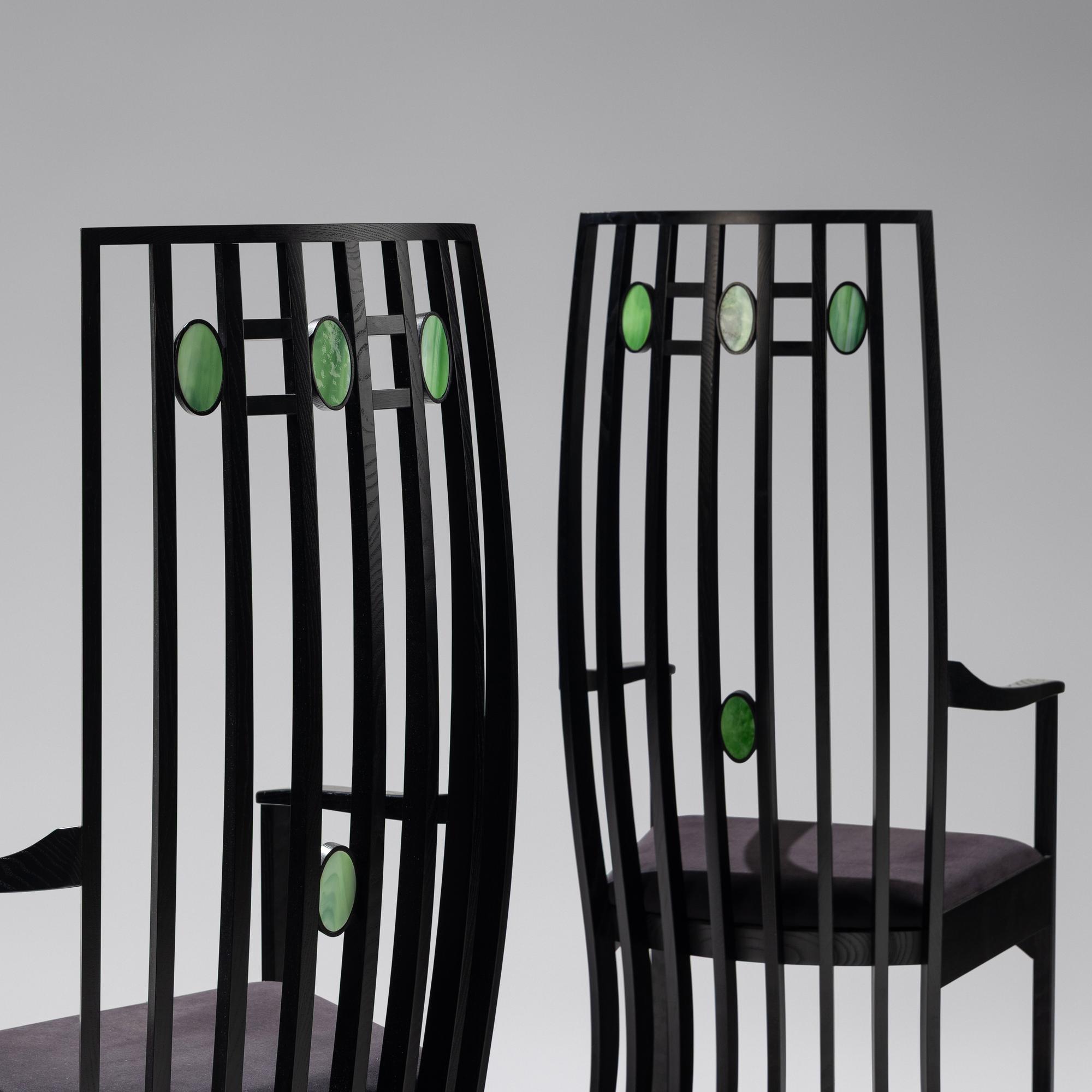 Pair of Cassina e bonized armchairs with slag glass inserts