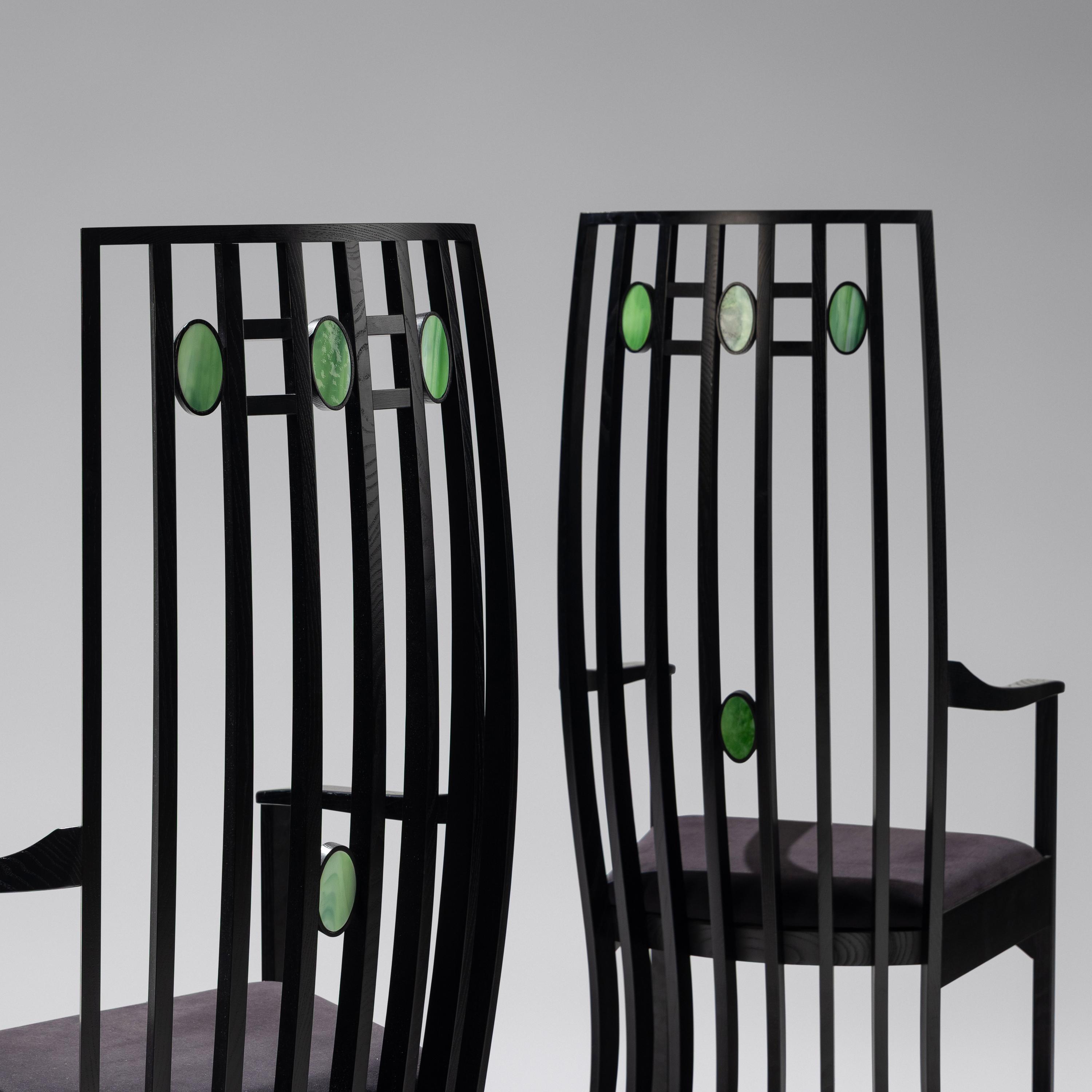 Pair of Cassina e bonized armchairs with slag glass inserts