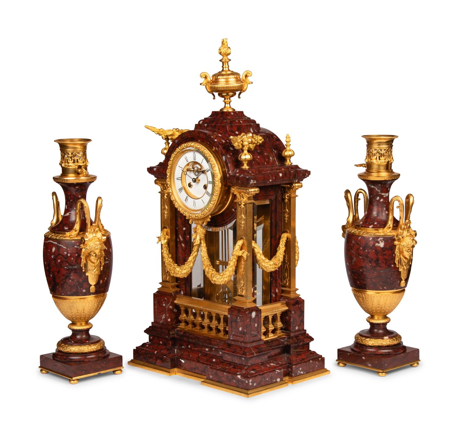 A Louis XVI Style Rouge Marble and Gilt Bronze Clock Garniture