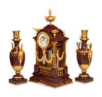 A Louis XVI Style Rouge Marble and Gilt Bronze Clock Garniture